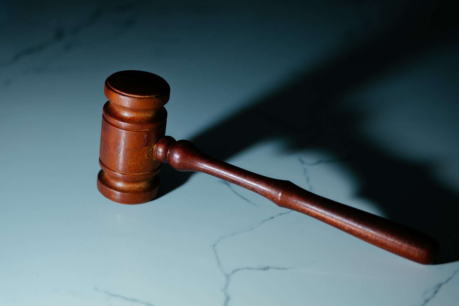 A wooden auctioneer's hammer on a table, representing an auction