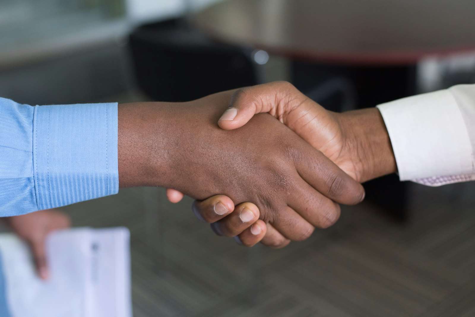 Two people shaking hands, representing starting a new job