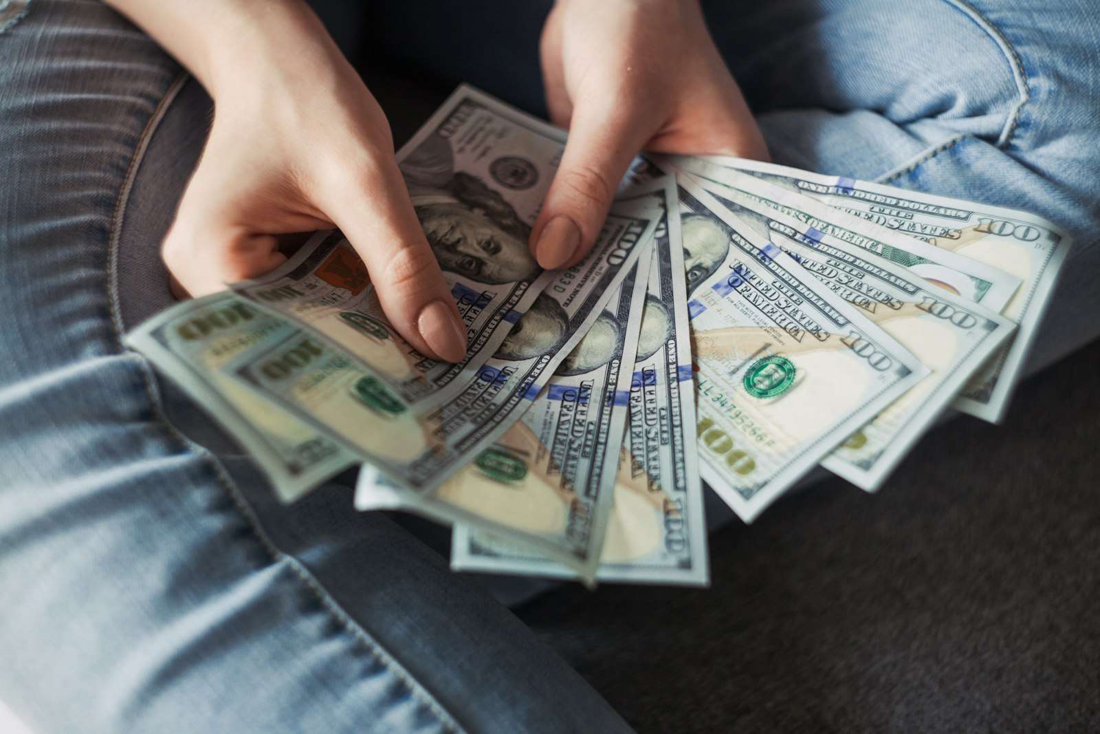 A fan of US dollar banknotes, representing a family gifted deposit