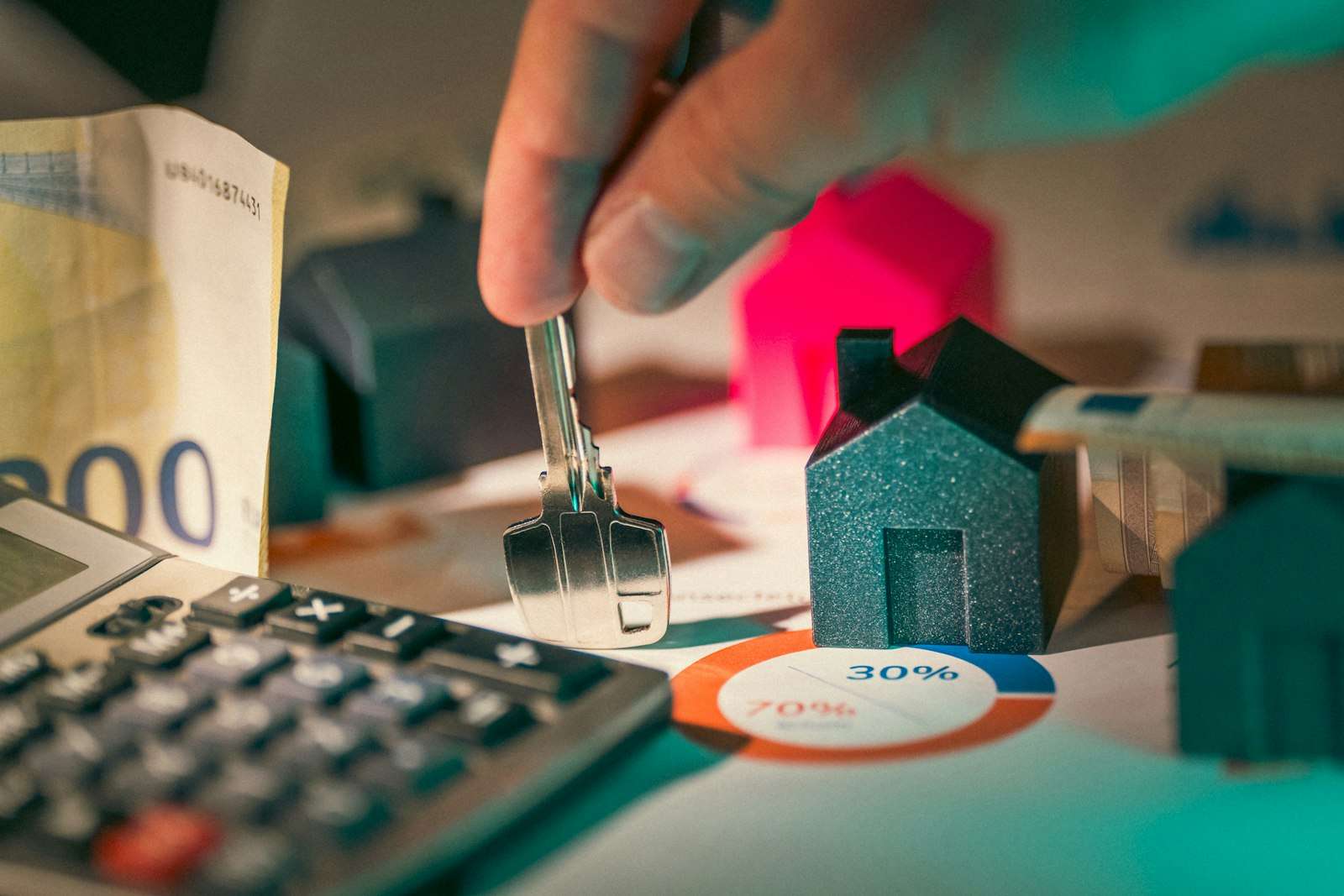 Hand holding a house key, representing a home loan repayment decision