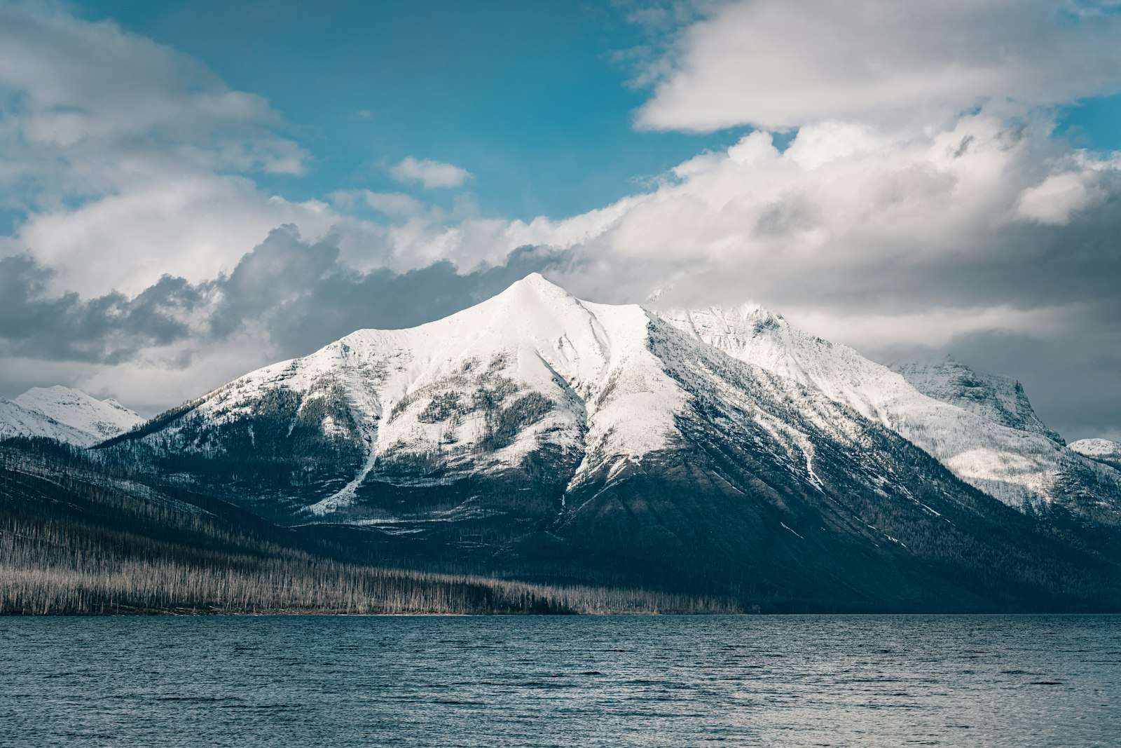 Snow covered mountain near a lake, representing the Snowy Monaro alpine region
